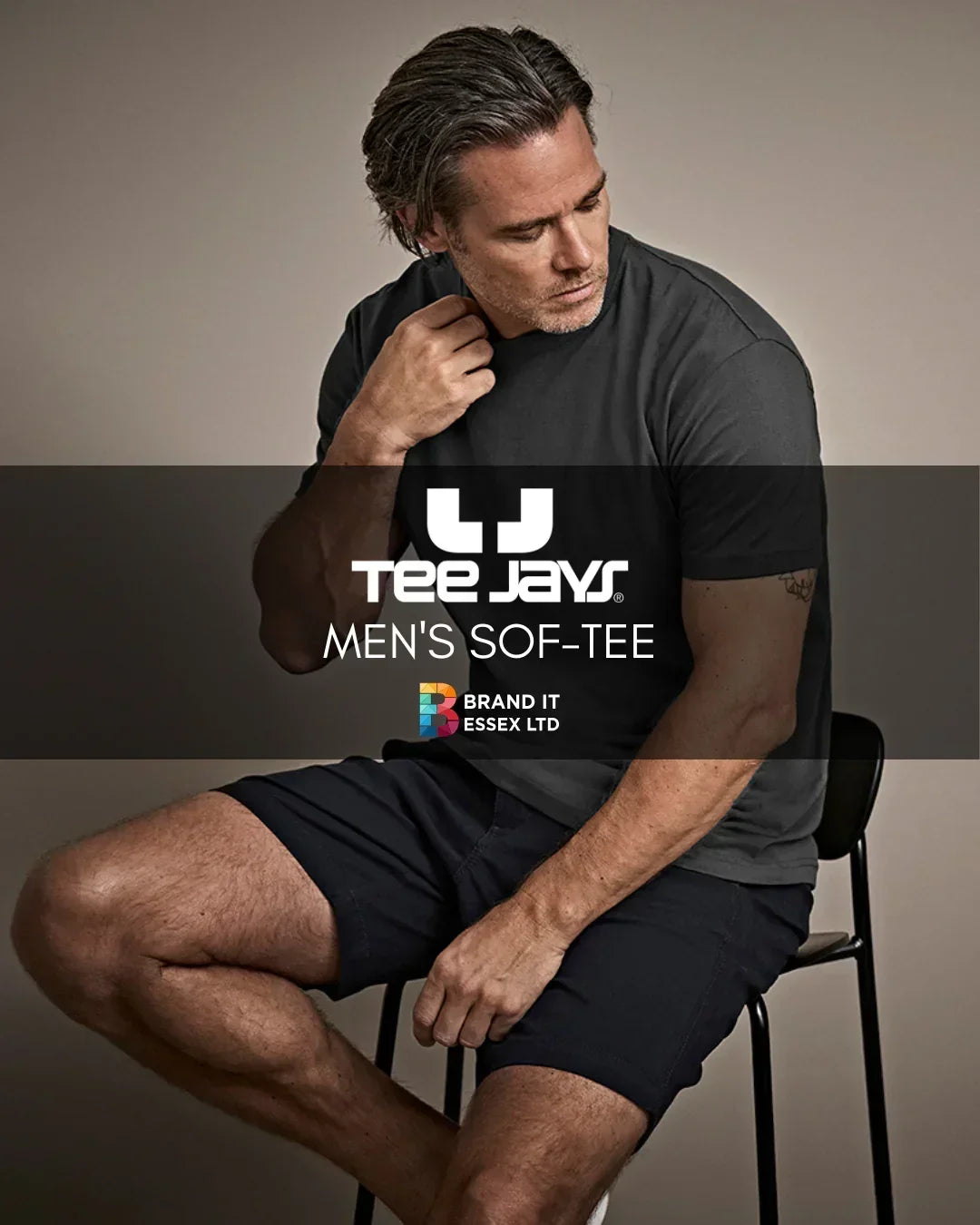 Custom branded Tee Jays men's Sof-Tee in black, modeled in studio by Brand It Essex Ltd.